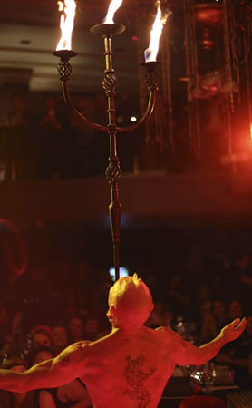 Finhead performing with the giant flaming candelabra for a live audience