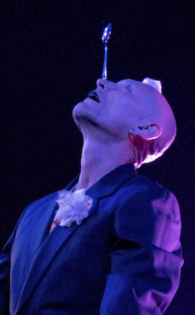 Finhead balancing a teaspoon on his nose during live performance